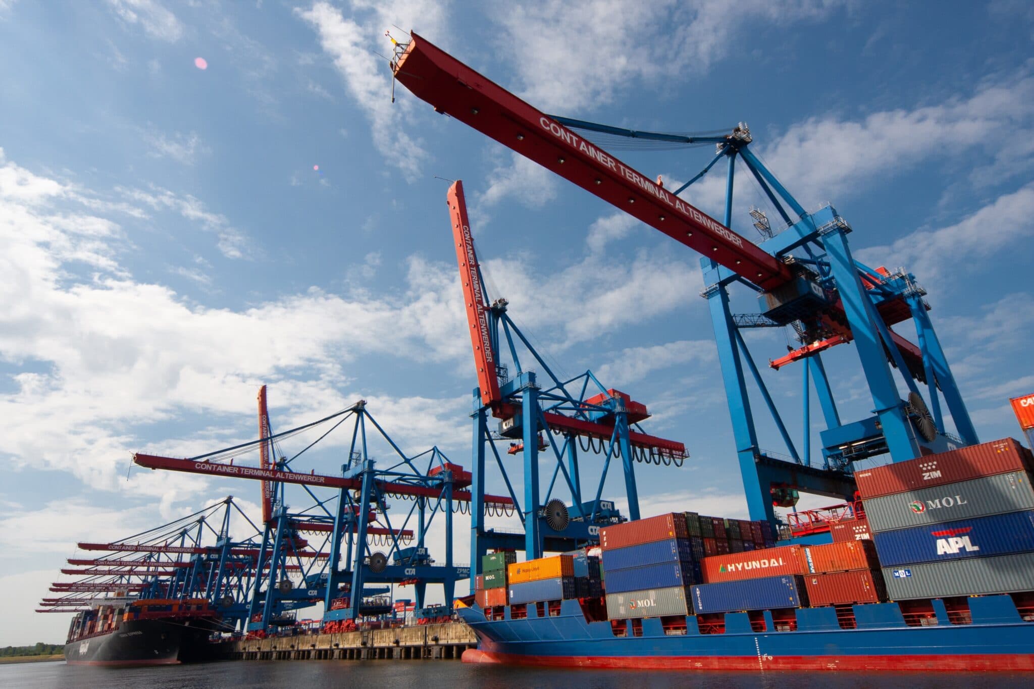 Container gantry cranes loading a vessel at a working port terminal